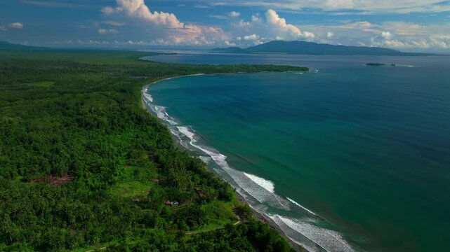 Mushu Yuo Island Cape Wom beach Dogreto Bay Madang Wewak Harbor View Papua New Guinea aerial drone Kavieng Vanimo Tufi coastline sunny blue sky clouds untouched remote tropical shore waves down motion