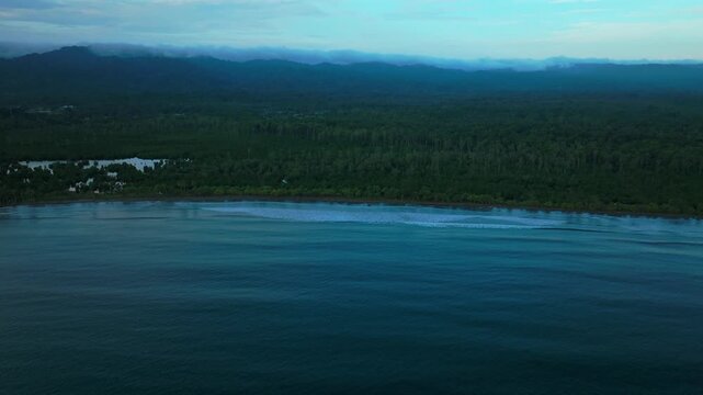 Wewak Cape Wom Meri beach Dogreto Bay Madang Harbor View Papua New Guinea aerial drone Kavieng Vanimo Tufi coastline rain clouds fog untouched morning remote tropical shore waves forward pan up