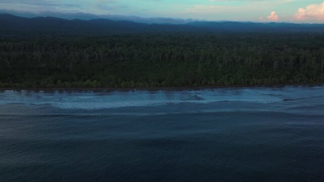 Morning pristine untouched remote tropical beach shore coastline wave swell Wewak Papua New Guinea aerial drone rain clouds fog Cape Wom Meri beach Dogreto Bay Madang Kavieng Vanimo forward motion