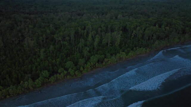 Morning pristine untouched remote tropical beach shore coastline Wewak Papua New Guinea aerial drone wave swell rain clouds fog Cape Wom Meri beach Dogreto Bay Madang Kavieng Vanimo backwards pan up