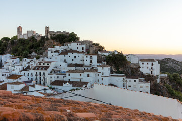 Fototapeta premium Casares, Andalusia, Spain. 5 September 2025. Whitewashed village and castle hill at sunset.