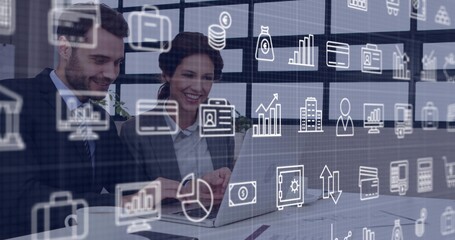 Reviewing business professionals working on laptop in modern office, with finance charts overlaying