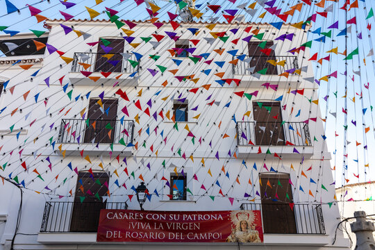 Fototapeta Colorful flags decorating Casares streets for village festival. Casares, Andalusia Spain. 5 September 2025.