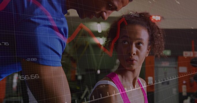 Leaning trainer in sportswear guiding client pressing weights at gym bench press with data overlay