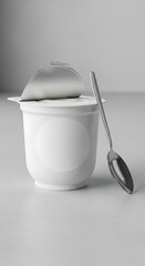 Minimalistic yogurt cup mock-up with a sleek metallic spoon, packaging