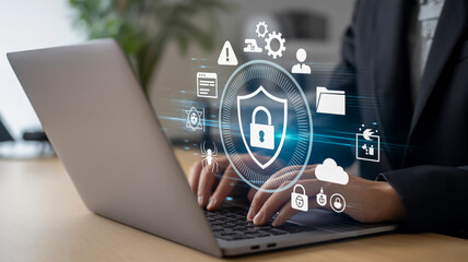 Cybersecurity concept with digital shield and icons over laptop