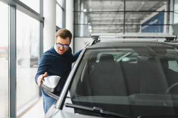 Handsome bearded buyer in casual wear in dealership