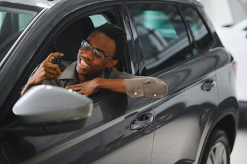 African american Man buying a car at a showroom
