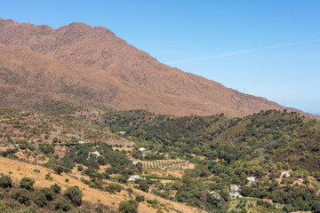 Obraz premium Mountain landscape near Casares with green hills and blue sky. Casares, Andalusia Spain. 5 September 2025.