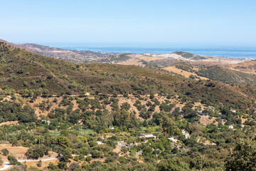 Obraz premium Mountain landscape near Casares with green hills and blue sky. Casares, Andalusia Spain. 5 September 2025.