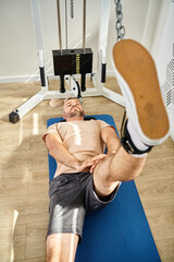 Man actively engaged in rehabilitation exercises at a modern physical therapy clinic