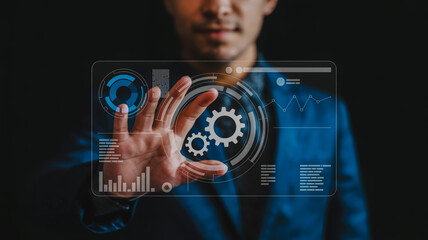 Man interacting with futuristic holographic interface displaying gears and data