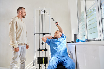 Rehabilitation process between patient and physiatrist in a modern therapy center