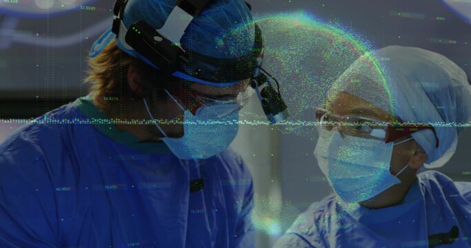 Performing surgery two surgeons wearing blue scrubs, headlamps at OR, with loupes and drapes