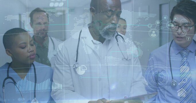 Healthcare team reviewing analytics graphics on tablet in hospital corridor, with stethoscopes