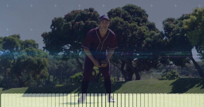 Asian baseball player holding glove and gripping ball on outfield, wearing cap and jersey - Powered by Adobe