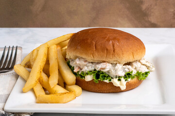 shrimp seafood salad sandwich with fries