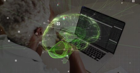 Senior researcher examining code on laptop in lab, holographic brain, interface icons, copy space