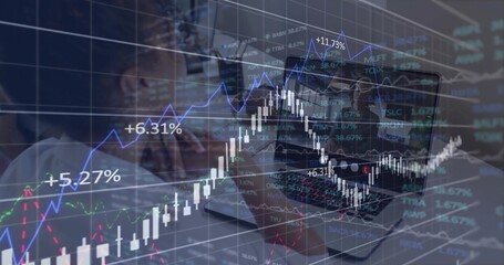 Analyzing colleagues in business outfits studying laptop at office with chart overlays, copy space