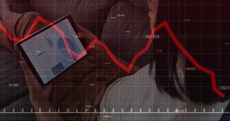 Leaning forward two professionals reviewing tablet chart data at office lounge, with red overlay