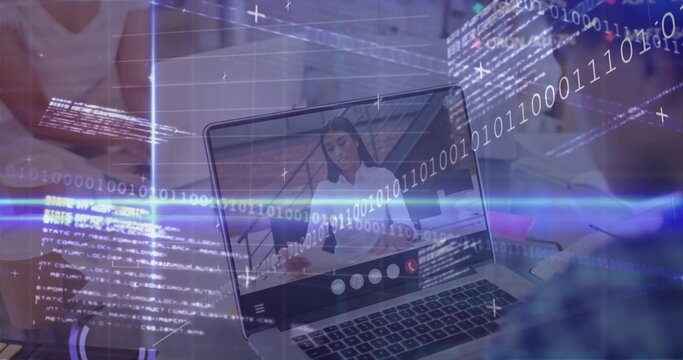 Watching colleague wearing white blouse sharing code on laptop at office desk, with binary overlay - Powered by Adobe