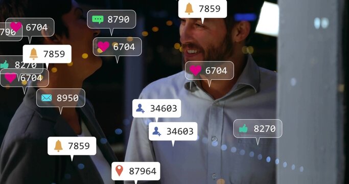 Smiling business colleagues chatting on balcony at night, with floating social media notifications