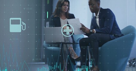 Colleagues wearing suits analyzing reports and laptop data in office lounge, with data overlay
