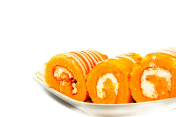 Orange Jam Roll Cake is a snack with Tea or coffee on a white background. Use lights and flash for clarity.