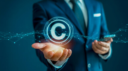 Businessman holding a glowing copyright symbol in a digital network