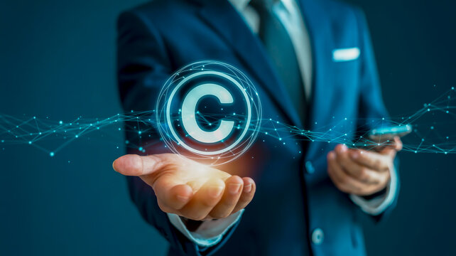 Businessman holding a glowing copyright symbol in a digital network
