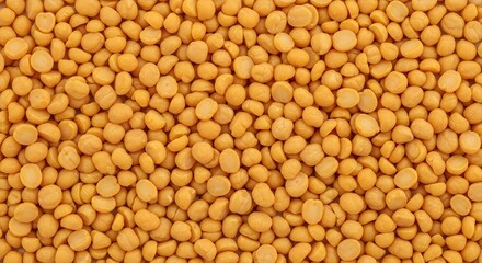 Fototapeta premium Vibrant yellow split peas create a captivating, textured background for healthy food and culinary projects.
