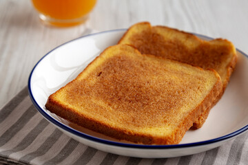 Homemade American Cinnamon Toast with Butter and Orange Juice, low angle view.