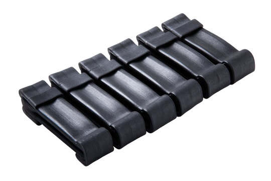 Black polymer conveyor belt sections.  Stacked, flat.  Industrial component