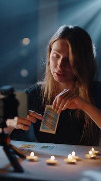 Fortune teller explaining tarot card meaning on video call