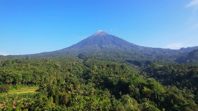 Aerial drone footage of Ebu Lobo volcano mountain and its forest around, in Flores island, Indonesia, during a full sunny day