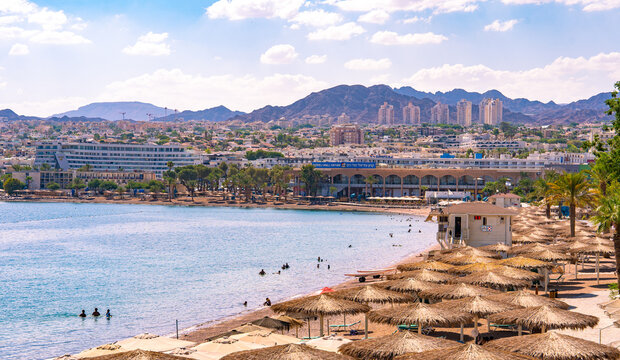 Panoramic view of the resort city of Eilat. Hotels and the Red Sea with people swimming on the central beach.