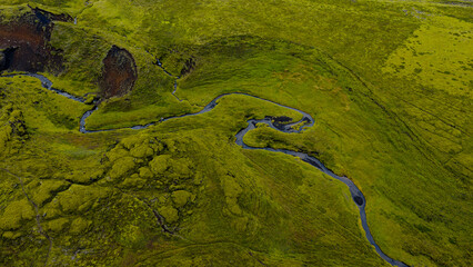 Aerial View of a Winding River in a Moss Covered Volcanic Landscape