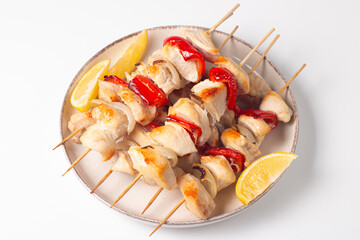 Grilled chicken skewers. Satay with side lemon and salad. Kebab with sauces. 