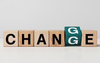 Conceptual image of the word change on wooden blocks with one cube turning, symbolizing transition and evolution