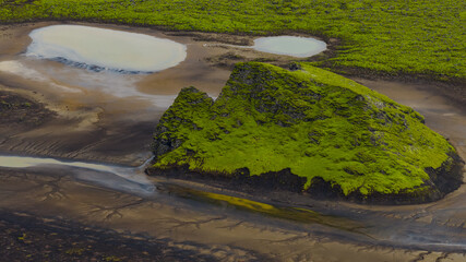 Aerial View of Moss Covered Volcanic Hill and Winding Streams in Iceland