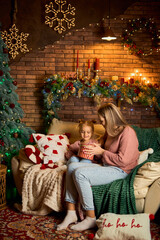 A mother and daughter opening a magical gift