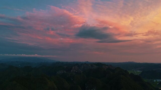 Aerial Time-Lapse of Sunset Glow Reflecting on Karst Peaks