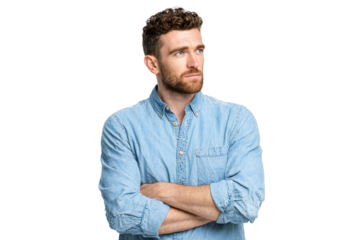 Confident young man with beard in denim shirt crossing arms, looking away with serious expression, isolated on white background