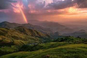 Panoramic mountain vista at sunset, rainbow arches over rolling hills