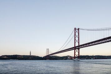Fototapeta premium 25 de Abril Bridge over the Tagus with Cristo Rei, Lisbon, Portugal