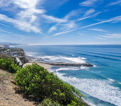 Clifftop view over Praia das Maçãs bay and breakwaters, Sintra - Powered by Adobe