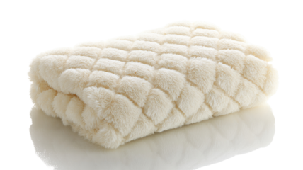 Folded cream-colored plush blanket with diamond quilting