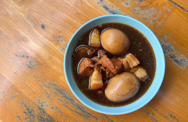 Top view Boiled Eggs in Sweet Brown Soup or Five-Spice Egg in a small bowl with natural light, or called  Kai Paloh in Thai language. One of healthy Asian food.
