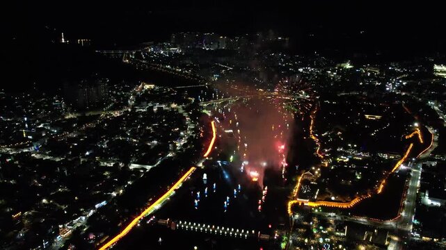 Drone aerial view of Jinju Namgang River with floating lanterns at the Yudeung Festival night scene in South Korea