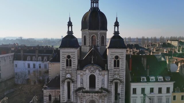 Drone view of historic cathedral in Chalon sur Saone France with domed roof twin towers and surrounding old town rooftops overlooking the Saone river under clear morning light